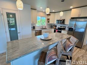 Kailua house for rent - A dining room with a wooden table and chairs.