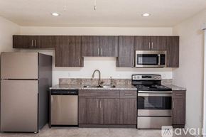 Lake Havasu City condo for rent - A kitchen with a refrigerator, stove, and microwave.