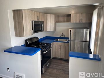 Detroit apartment for rent - A kitchen with a blue counter top and stove.