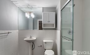 Highland Park apartment for rent - A white bathroom with a sink, toilet and shower.