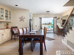 El Segundo townhouse for rent - A dining room with a wooden table and chairs.
