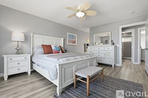 Oceanside apartment for rent - A bedroom with a large bed and a television.