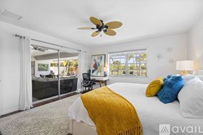 Jupiter apartment for rent - A bedroom with a large bed and a ceiling fan.