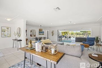 Jupiter apartment for rent - A living room with a grey couch and a wooden coffee table.