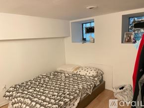 Chicago apartment for rent - A bedroom with a bed covered in a black and white patterned comforter.