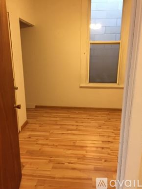 Chicago apartment for rent - A room with wooden flooring and a window.