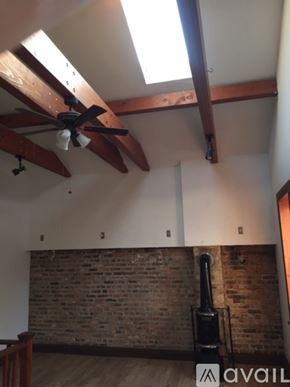 Chicago apartment for rent - A room with a ceiling fan and a brick wall.