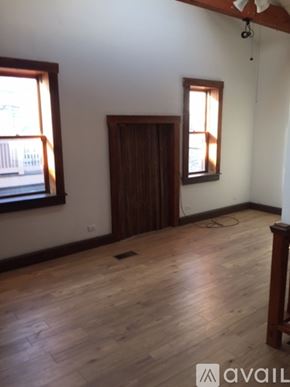 Chicago apartment for rent - A room with wooden floors and a ceiling fan.