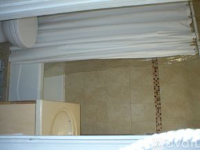 Chicago apartment for rent - A bathroom with a toilet and a tiled wall.