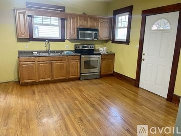 New Haven apartment for rent - A kitchen with wooden cabinets and a white door.