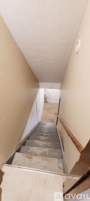 Canton townhouse for rent - A staircase with a metal railing and wooden steps.