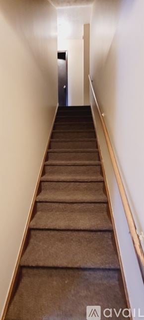 Canton townhouse for rent - A long staircase with a carpeted runner and wooden handrails.