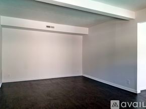 Dallas apartment for rent - A spacious room with a dark floor and white walls.