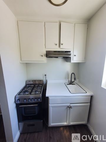 Hawthorne apartment for rent - A small kitchen with a stove and sink.