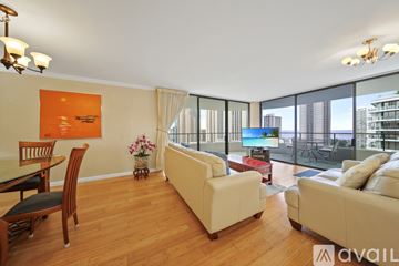 Honolulu condo for rent - A living room with a white couch and a television.