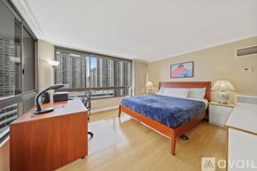 Honolulu condo for rent - A kitchen with white cabinets and appliances.