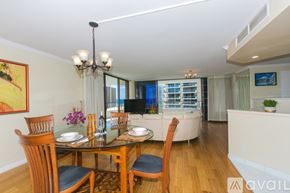 Honolulu condo for rent - A dining room with a glass table and chairs.