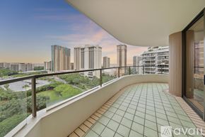 Honolulu condo for rent - A bedroom with a bed, a nightstand with a lamp, and a painting on the wall.