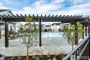 Lehi apartment for rent - A patio with a pergola and a pool in the background.