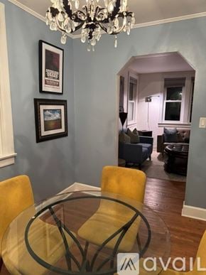 Nashville house for rent - A dining room with a glass table and yellow chairs.