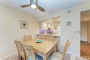 Bradenton condo for rent - A dining room with a wooden table and chairs.