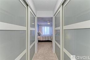 Bradenton condo for rent - A bedroom with a bed and a window with curtains.