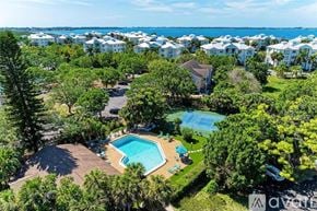 Bradenton condo for rent - A bird's eye view of a resort with a swimming pool surrounded by trees.