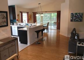 Naples condo for rent - A kitchen with a table and chairs in the middle of the room.