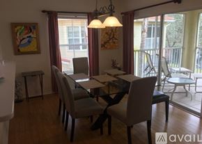 Naples condo for rent - A dining room with a table and chairs.