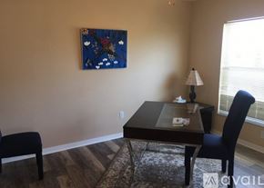 Naples condo for rent - A dining room with a table, chairs and a painting on the wall.