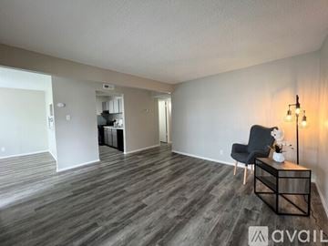 Victoria apartment for rent - A living room with a black chair and a wooden coffee table.