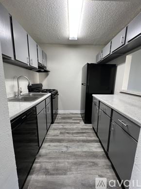 Victoria apartment for rent - A kitchen with black appliances and cabinets.
