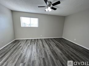 Victoria apartment for rent - A room with a ceiling fan and a window.