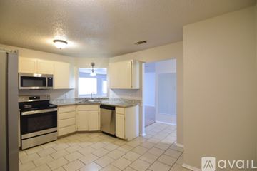Killeen house for rent - A kitchen with white cabinets and appliances.