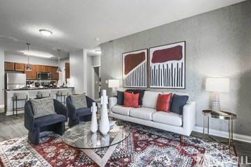 Powell apartment for rent - A living room with a white couch and a rug.