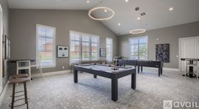 Powell apartment for rent - A spacious room with a pool table and a bar stool.