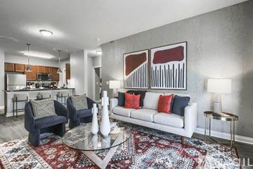 Powell apartment for rent - A living room with a white couch and a rug.