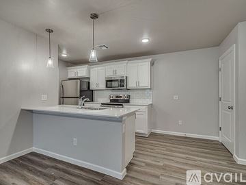 Oklahoma City house for rent - A kitchen with white cabinets and a white island with a sink.
