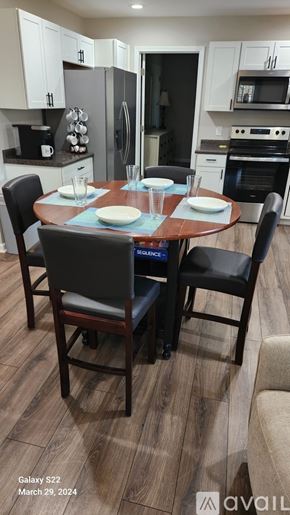 Greenville house for rent - A dining room with a table set for two and chairs around it.