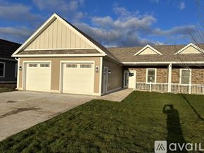 Rome townhouse for rent - A two-car garage with a brown roof and tan siding is available for rent.