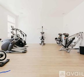 Lehi apartment for rent - A gym with a variety of exercise equipment including a stationary bike, a rowing machine, and a treadmill.