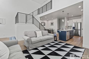 Lehi apartment for rent - A black and white checkered rug is on the floor of a modern living room.