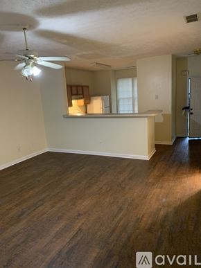 Riverdale house for rent - A room with a ceiling fan and wooden flooring.