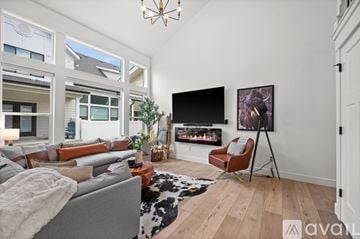 Midvale townhouse for rent - A living room with a grey couch and a black television.