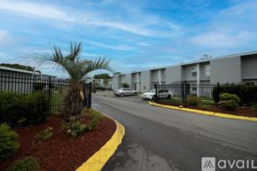 Gulfport apartment for rent - A street view of a residential area with apartment buildings and parked cars.