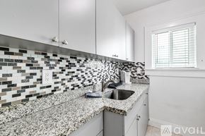 Miami apartment for rent - A kitchen with a sink and a window.