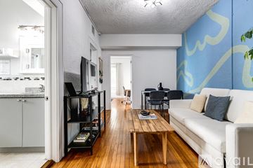 Miami apartment for rent - A living room with a white couch and a wooden coffee table.