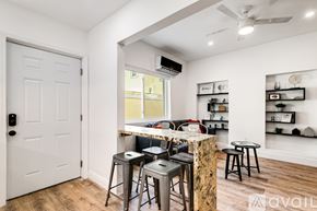 Miami apartment for rent - A room with a bar area and a door.