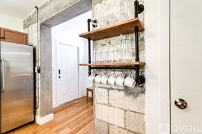 Miami apartment for rent - A kitchen with a refrigerator and a shelf with glasses on it.