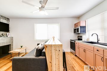 Miami apartment for rent - A living room with a grey couch and a wooden table.